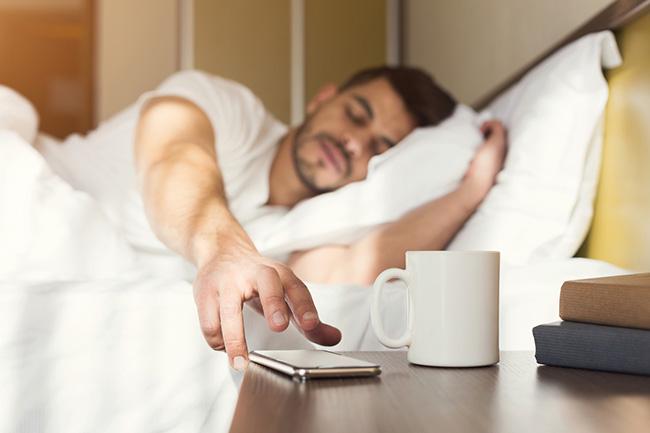 Man turning alarm off