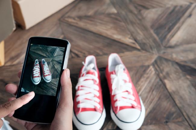 Someone taking photos of red and white shoes