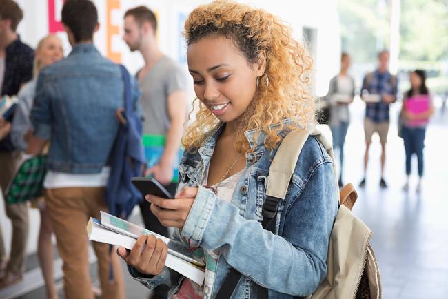 student looking at her phone