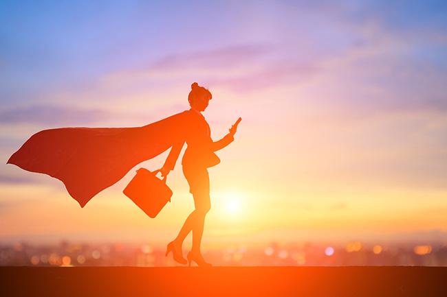 a super looking person with a cape a briefcase and looking at a phone