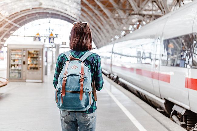 A person with a backpack in a train station