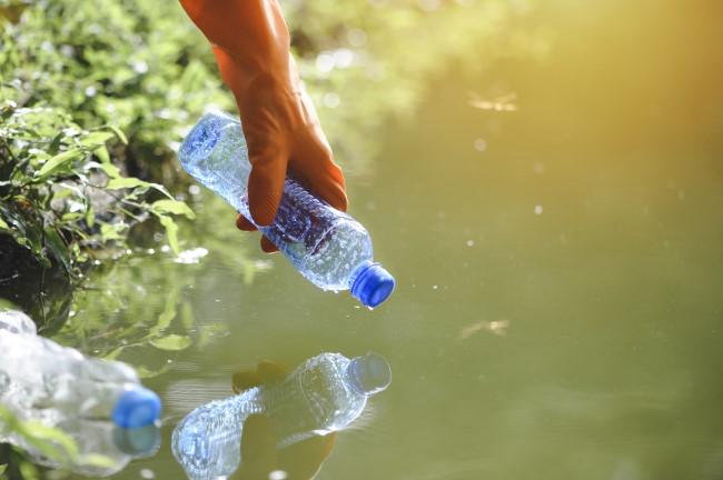 Cleaning up plastic bottle waste.