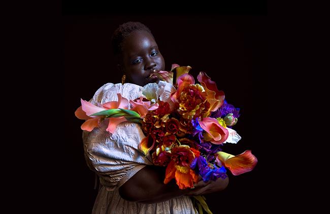 HD imge of woman holding colourful flowers